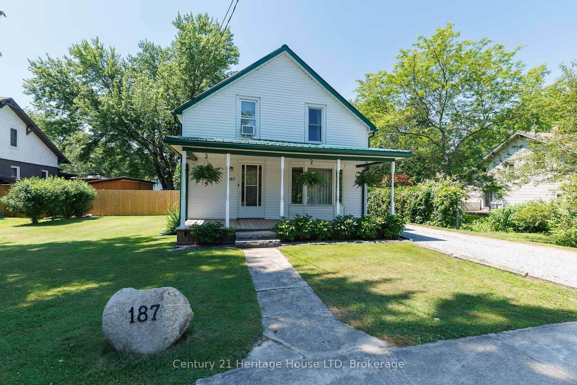Front Exterior - porch, fully fenced & stone drive