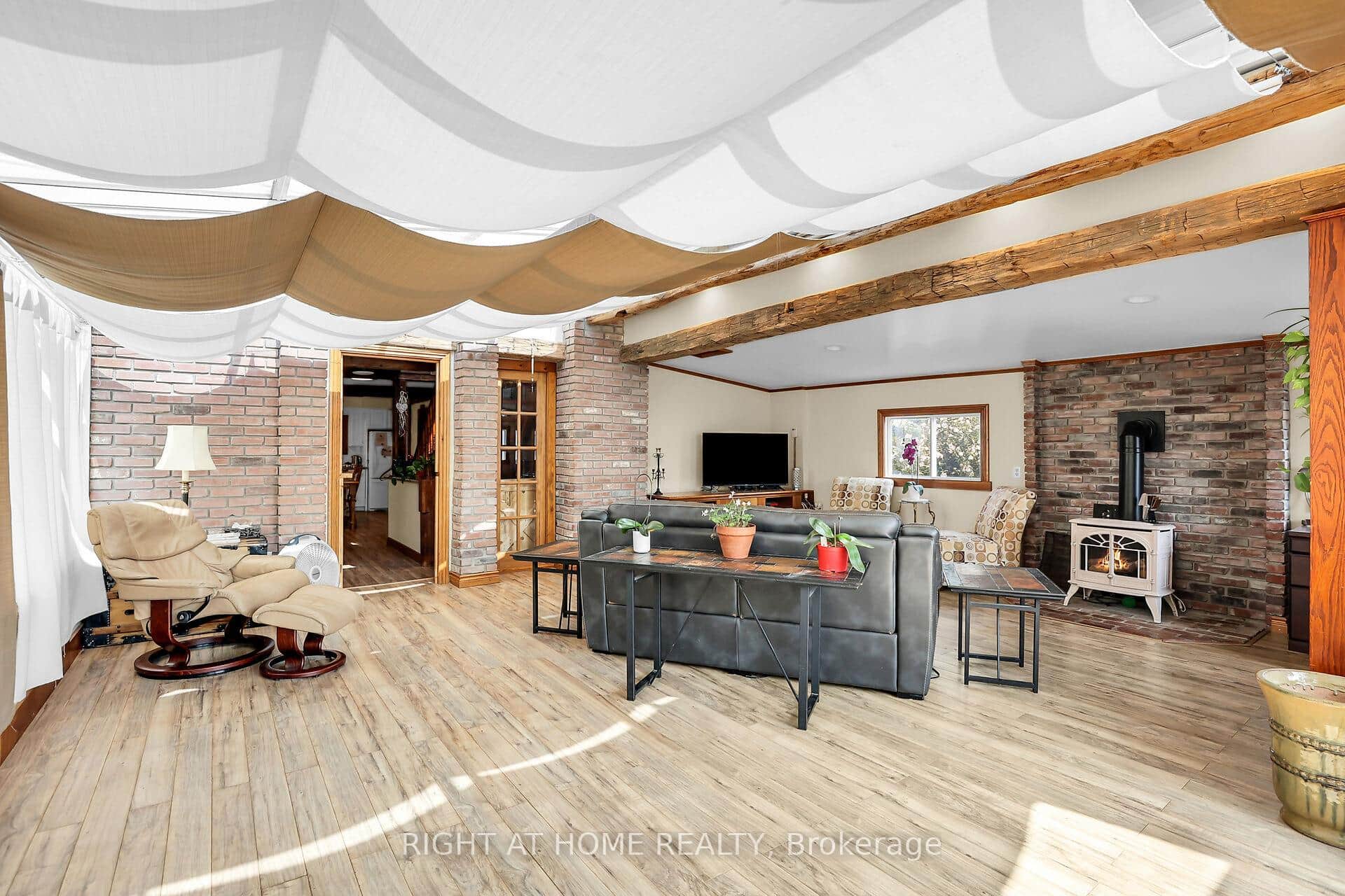 Sunlit living room with rustic charm & warmth