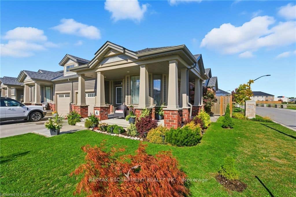 Covered porch, brick siding, a frt yard, driveway